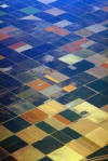 Aerial view showing various colors of plots of land - like a patchwork quilt
